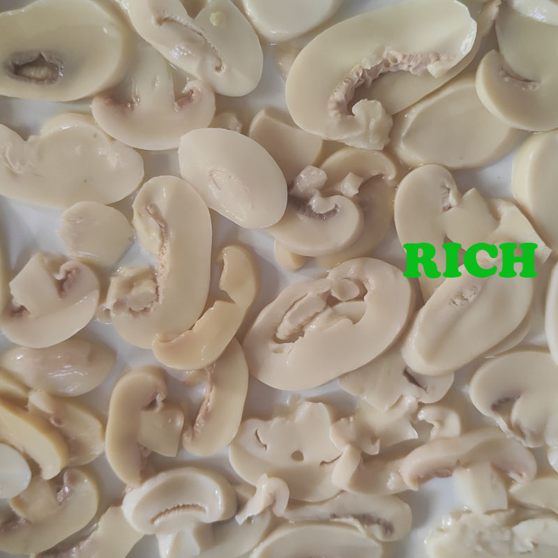 Sliced champignon mushroom in brine in drums