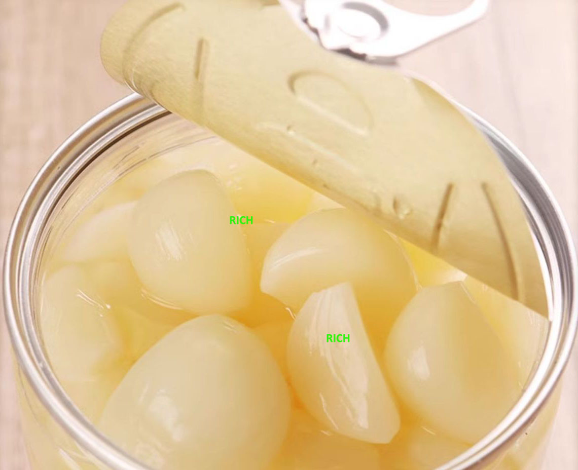 white garlic in brine in drums