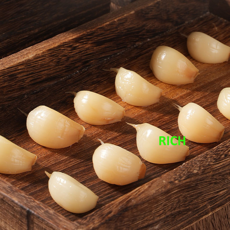 White garlic cloves in salted water